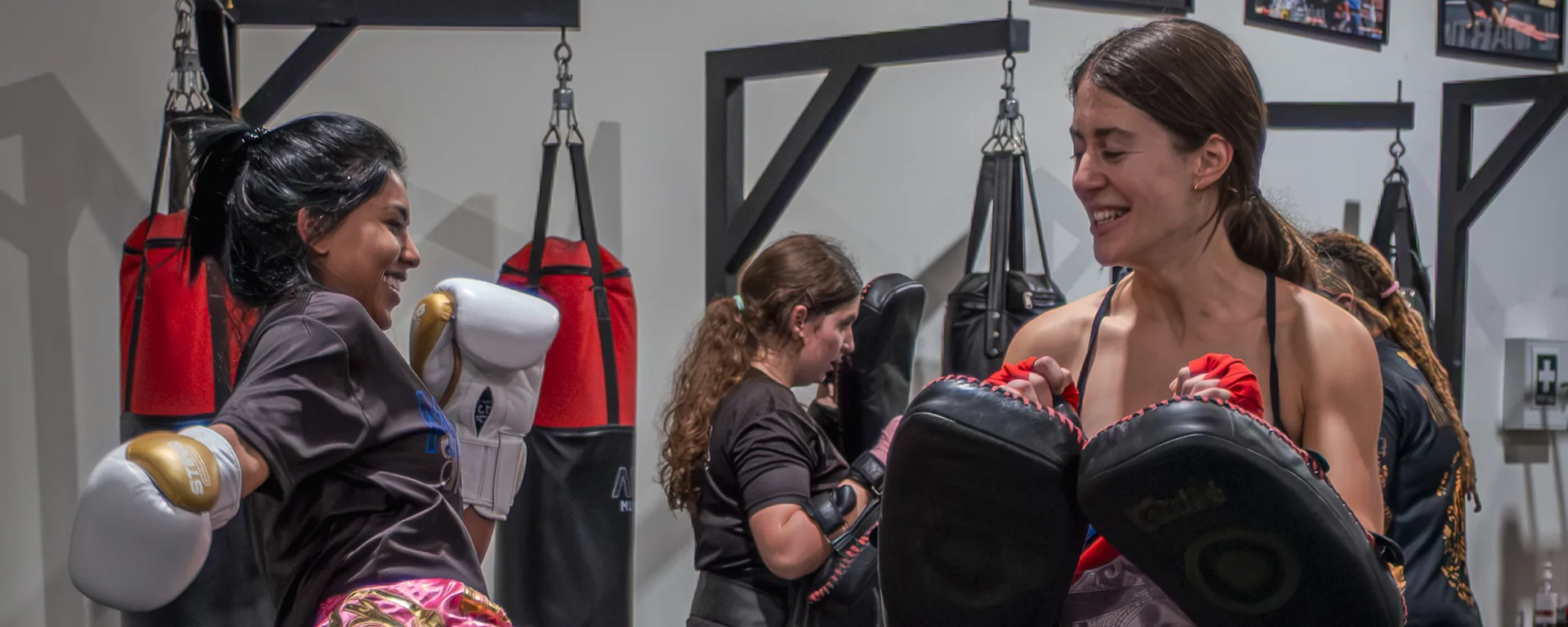 Two adults training together and having fun in a Muay Thai class at ACSA in Thornbury, Melbourne